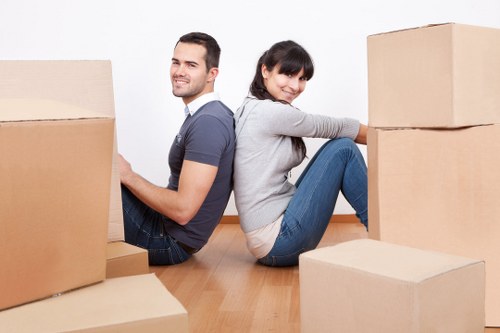 Professional movers carrying furniture during a Queensbury relocation