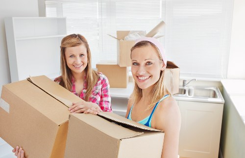 Careful wrapping of fragile belongings during a Queensbury packing service